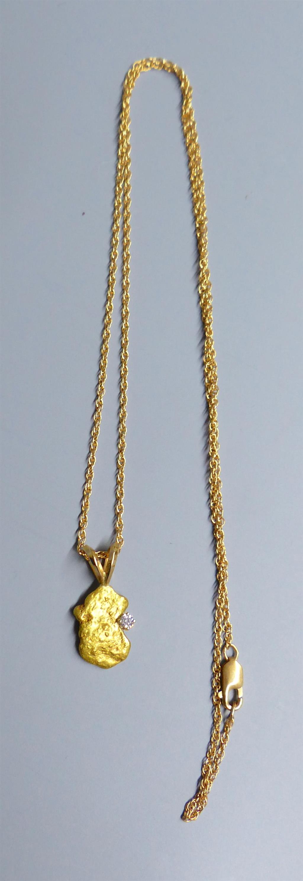 A diamond set gold nugget pendant, 12mm, gross 2.1grams, on a 585 fine link chain, 1.4 grams.